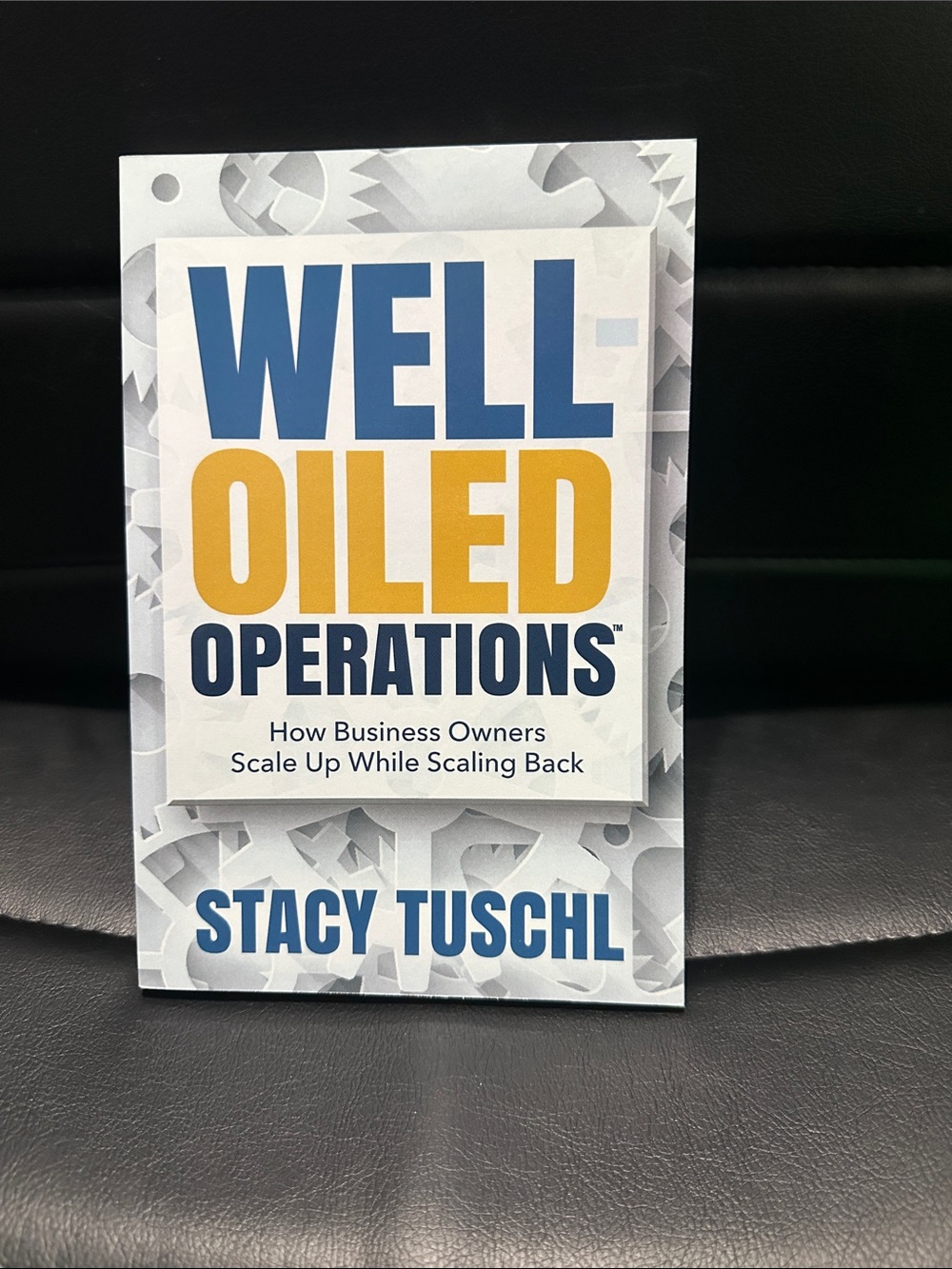 Book “Well-Oiled Operations” by Stacy Tuschl - Blue & Yellow Cover